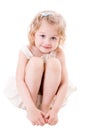 Smiley little girl sitting on white Royalty Free Stock Photo