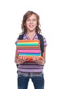 Smiley little student holding some books