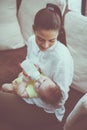 Smiley mother and baby girl at home.