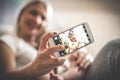 Smiley mother with her baby boy at home taking self portrait. Royalty Free Stock Photo