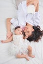 Smiley mother and her baby looking at you lying on the floor at home Royalty Free Stock Photo
