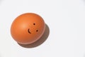 Smiley is painted on a chicken egg on a white background Royalty Free Stock Photo