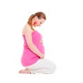 Smiley pregnant woman sitting on the floor Royalty Free Stock Photo