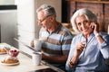 Smiley retired couple having morning coffee in the kitchen Royalty Free Stock Photo