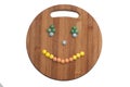 Smiley of the round chocolate candies on a wooden board Royalty Free Stock Photo