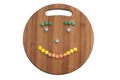 Smiley of the round chocolate candies on a wooden board Royalty Free Stock Photo