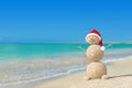 Smiley sandy snowman in santa hat. Holiday concept for New Years