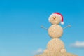 Smiley sandy snowman in santa hat. Holiday concept for New Years