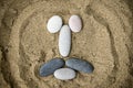 Smiley of stones on sand closeup