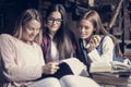 Smiley students girls reading file.