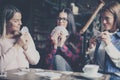 Three best friends in cafe playing together game cards. C Royalty Free Stock Photo
