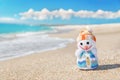 Smiley toy christmas snowman at hot sea beach. Royalty Free Stock Photo