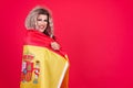 Smiley transgender person wrapping with a spanish flag
