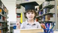 Smiley white boy with the Graduation cap and diploma paper stand Royalty Free Stock Photo