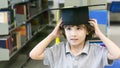 Smiley white boy with the Graduation cap and diploma paper stand Royalty Free Stock Photo