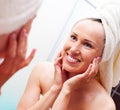 Smiley woman looking at mirror after shower