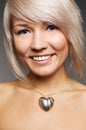 Smiley woman with silver heart Royalty Free Stock Photo