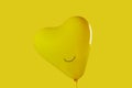 smiley yellow heart-shaped balloon