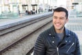 Smiley young ethnic male using public transportation