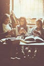 Young three students girls at cafe using smart phone. Royalty Free Stock Photo