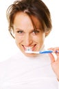 Smiley young woman cleaning her teeth