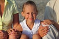 Smiliing daughter sitting between parents on beach Royalty Free Stock Photo