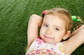 Smililing little girl lying on grass Royalty Free Stock Photo