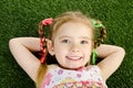 Smililing little girl lying on grass Royalty Free Stock Photo