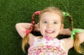 Smililing little girl lying on grass Royalty Free Stock Photo