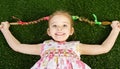 Smililing happy little girl lying on grass Royalty Free Stock Photo