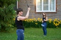 Smilind adult woman plays badminton with her daughter near the country house Royalty Free Stock Photo