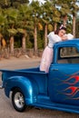 Smiling 1950s teen girl in pickup truck Royalty Free Stock Photo