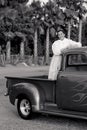 Smiling 1950s teen girl in pickup truck Royalty Free Stock Photo