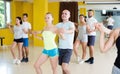 Active adults dancing bachata in modern dance studio