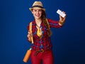 Smiling active woman hiker showing tablets in blister pack