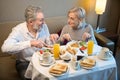 Smiling adult caucasian couple having breakfast and looking at each other Royalty Free Stock Photo