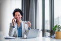 Smiling adult female executive, making a business call, having a glass of water Royalty Free Stock Photo