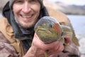 Happy fisherman holding large trout Royalty Free Stock Photo