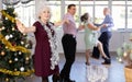 Smiling adult lady in elegant clothes dancing in couple latin dance, energetic and fast jive in dance salon during