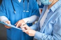 Smiling adult man doctor and european elderly lady patient signing documents in clinic office interior, cropped Royalty Free Stock Photo