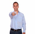 Smiling adult man pointing with remote control Royalty Free Stock Photo