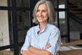 Portrait of smiling business woman standing in home office.