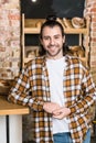 smiling adult seller standing at workplace