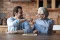 Smiling adult son and old dad play board game Royalty Free Stock Photo