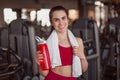 Smiling adult sportswoman with bottle