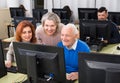 Students of different ages looking at monitor Royalty Free Stock Photo