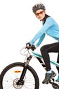 Smiling adult woman cyclist riding a bicycle.