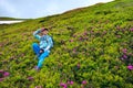 Adventurer female relaxing among flowering rhododendrons Royalty Free Stock Photo
