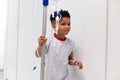 Smiling african american boy patient walking with drip stand in hospital corridor with copy space Royalty Free Stock Photo