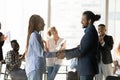 Smiling African American business partners shaking hands at meeting Royalty Free Stock Photo